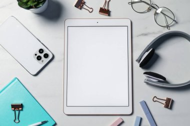 Tablet ve kırtasiyeli düz kompozisyon beyaz mermer masa üzerinde
