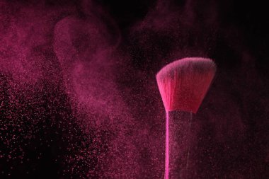 Siyah arka planda pembe göz farlı makyaj fırçası, yakın plan.