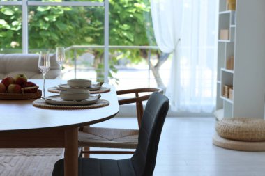 Yemek odasında güzel bir masa, sandalye ve dekor var. İç tasarım