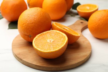 Beyaz masadaki portakalların tamamını kes, yakın plan.