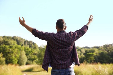 Özgürlüğü hissetmek. Adam dışarıda eğleniyor, arka manzara