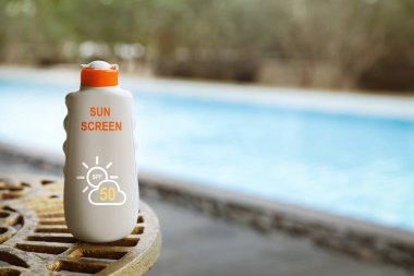 Yüzme havuzunun yanında güneş kremi. Güneş koruma ürünü