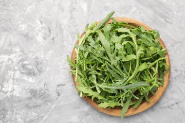 Taze yeşil roka yaprakları gri masada, üst tarafta. Metin için boşluk