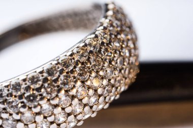 Işıklı arka planda parlak elmasları olan güzel bir yüzük, makro manzara.