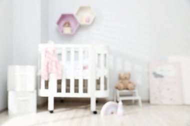 Bebek odasının içinde konforlu beşik ve diğer mobilyalar, bulanık manzara
