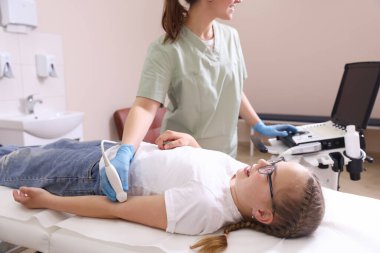 Sonograf, klinikte kızın kolunun ultrason muayenesi yapıyor.