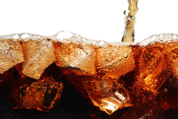 Pouring refreshing cola into glass with ice isolated on white