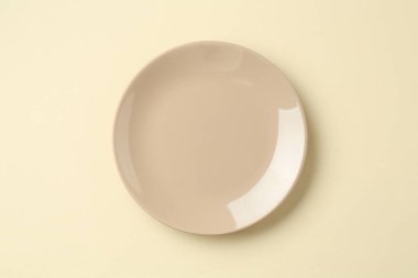 Bej arka planda şık bir plaka, üst görünüm