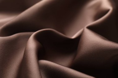 Arkaplan olarak buruşuk açık kahverengi ipek kumaş, yakın plan