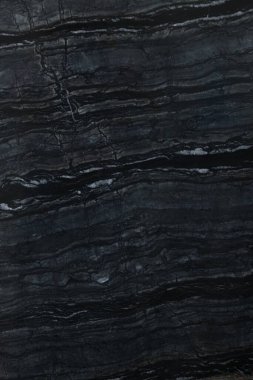 Arkaplan olarak koyu mermer yüzeyin dokusu, üst görünüm