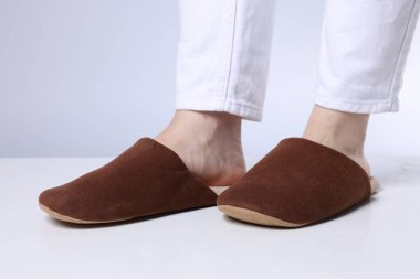 Hafif kahverengi terlikli kadın gri arka planda, yakın plan.