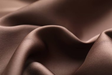 Arkaplan olarak buruşuk açık kahverengi ipek kumaş, yakın plan