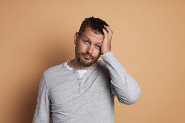 Bej arka planda akşamdan kalma bir adam.