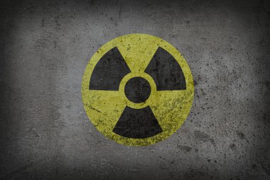 Gri desenli yüzeyde radyoaktif işaret var. Radyolojik kirlilik