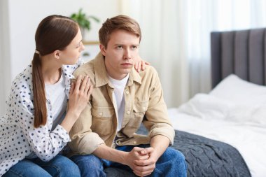 Genç bir kadın evde, erkek arkadaşından özür diliyor.