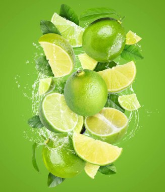 Yeşil arka planda taze limon ve su sıçratan bir içecek.