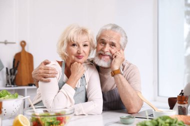 Evde birlikte yemek yedikten sonra yaşlı bir çiftin portresi.