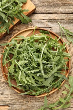 Taze yeşil roka yaprakları ahşap masanın üzerinde, düz yatıyordu.