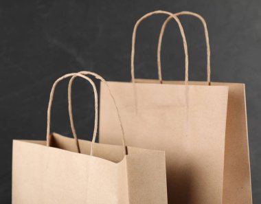 Bulanık arkaplanda Kraft kağıt torbaları, yakın plan.