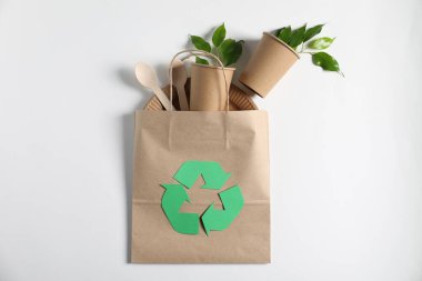 Geri dönüşüm sembolü, farklı çevre dostu ambalaj ve beyaz arka planda yapraklar, düz yatıyordu