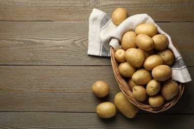 Tahta masada, sepetin içinde taze patatesler. Metin için boşluk