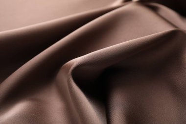 Arkaplan olarak buruşuk açık kahverengi ipek kumaş, yakın plan