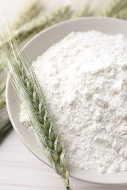 Yeşil buğday başakları ve un ışık masasında, yakın plan.