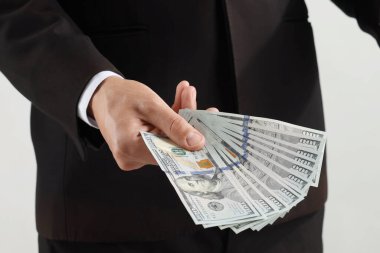 Arka planda dolar banknotları olan adam, yakın plan.