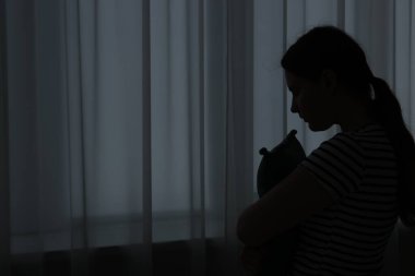 Evdeki üzgün genç kadının silueti. Metin için boşluk