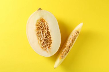 Sarı arka planda taze olgun kavun kes, düz uzan.