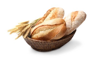 Taze ekmek somunları ve beyaz arka planda dikenler.