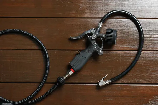 Ahşap arka planda göstergesi olan bir enflasyon tabancası.