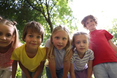 Sevimli küçük çocuklar parkta birlikte eğleniyorlar, düşük açılı.