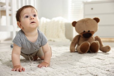 Odada yerde sürünen tatlı küçük bebek.