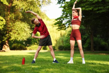 Mutlu çift parkta sabah egzersizi yapıyor.