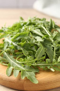 Taze yeşil roka yaprakları açık ahşap masada, yakın plan.