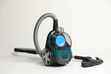 Açık gri arkaplanda bir elektrikli süpürge