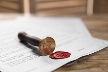 Balmumu mühür ve damgalı belgeler ahşap masaya, yakın plan.