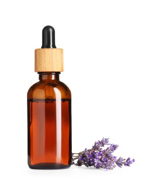 Lavanta yağı şişede. Çiçekler beyazın üzerinde.