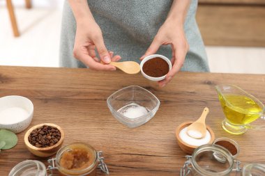 Doğal temizlik yapıyorum. Ahşap masada kahveye kahve katan kadın, yakın plan.