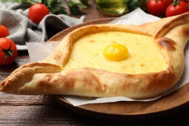 Peynirli, yumurtalı, domatesli ve maydanozlu lezzetli khachapuri.
