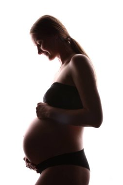 Beyaz arka planda hamile kadın silueti