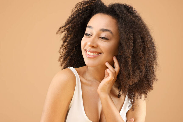 Portrait of beautiful Brazilian woman on beige background
