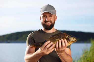 Gülen balıkçılar yazın göl kenarında balık yakalarlar.