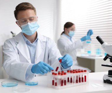 Tıbbi analiz. Laboratuvarda kan örneğiyle çalışan bir bilim adamı.