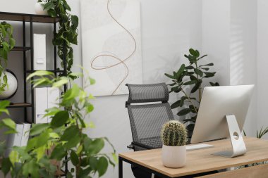 Biyofilik iç tasarım. Ofisinde bilgisayar ve ev bitkileri olan şık bir iş yeri