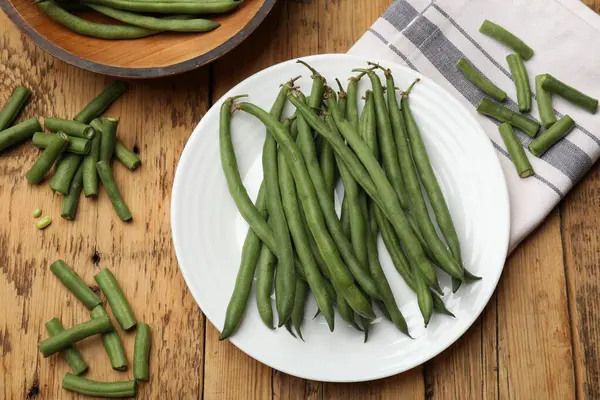 Tahta masada bir sürü çiğ yeşil fasulye vardı.