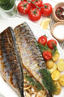 Baharatlı, domatesli ve patatesli kızarmış uskumrular. Ev yapımı deniz ürünleri yemeği.