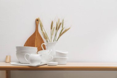 Farklı beyaz bulaşık takımları, tahta kesme tahtaları ve tahta çiviler kapalı masa, yazı için yer