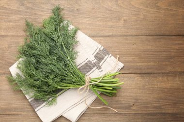 Ahşap masanın üstünde taze dereotları var. Metin için boşluk